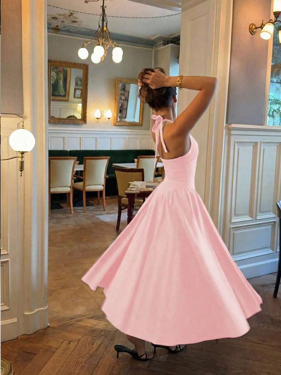 Back View of blush pink halter A-line cocktail dress with open back for wedding and party styling