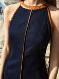 Close front view of dark indigo denim dress halter neck and leather-look contrast trim