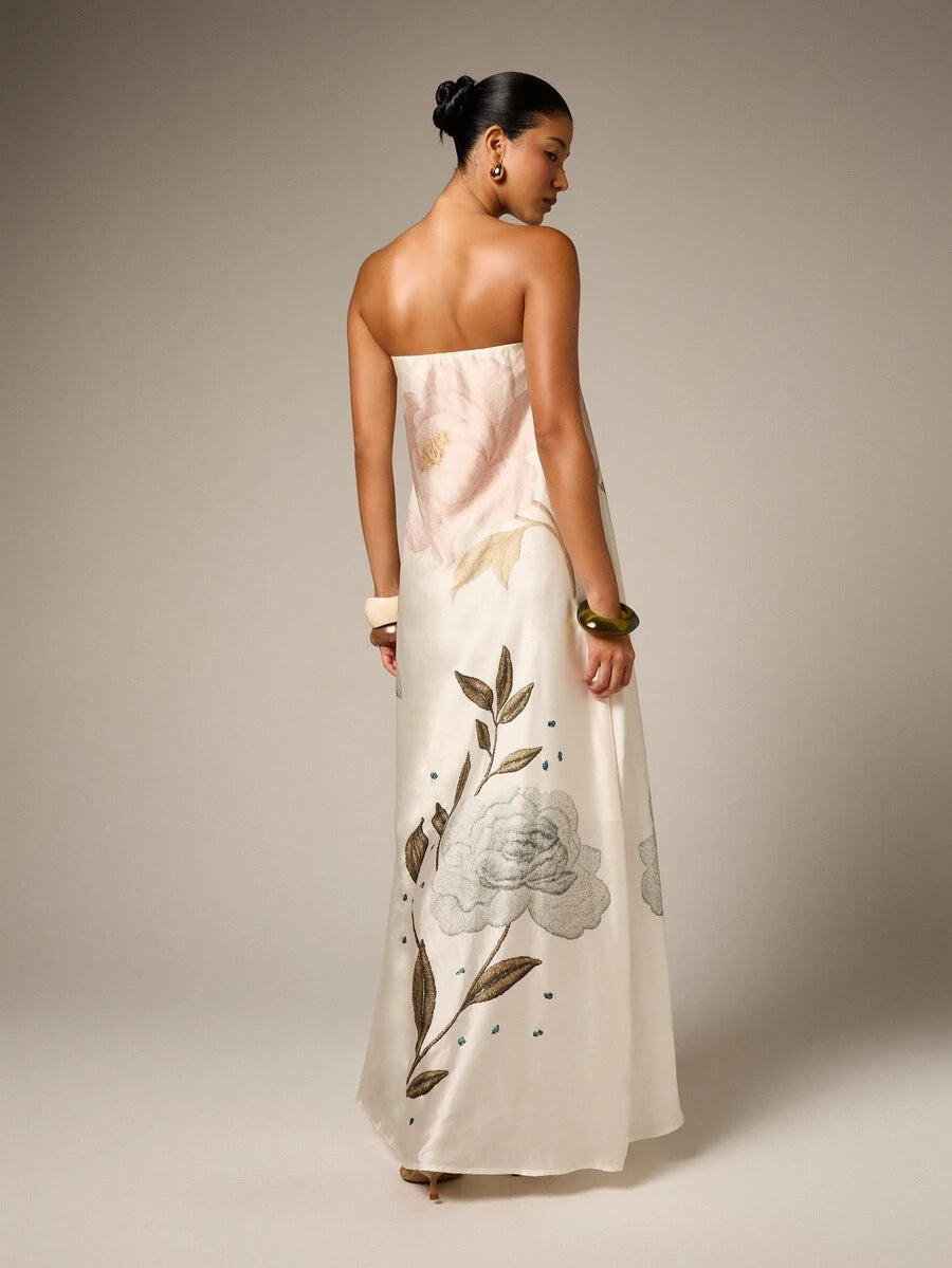Back view of ivory floral embroidered maxi gown with long flowing skirt