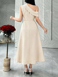 Back view of ivory asymmetric A-line midi dress with diagonal shoulder band in marble interior
