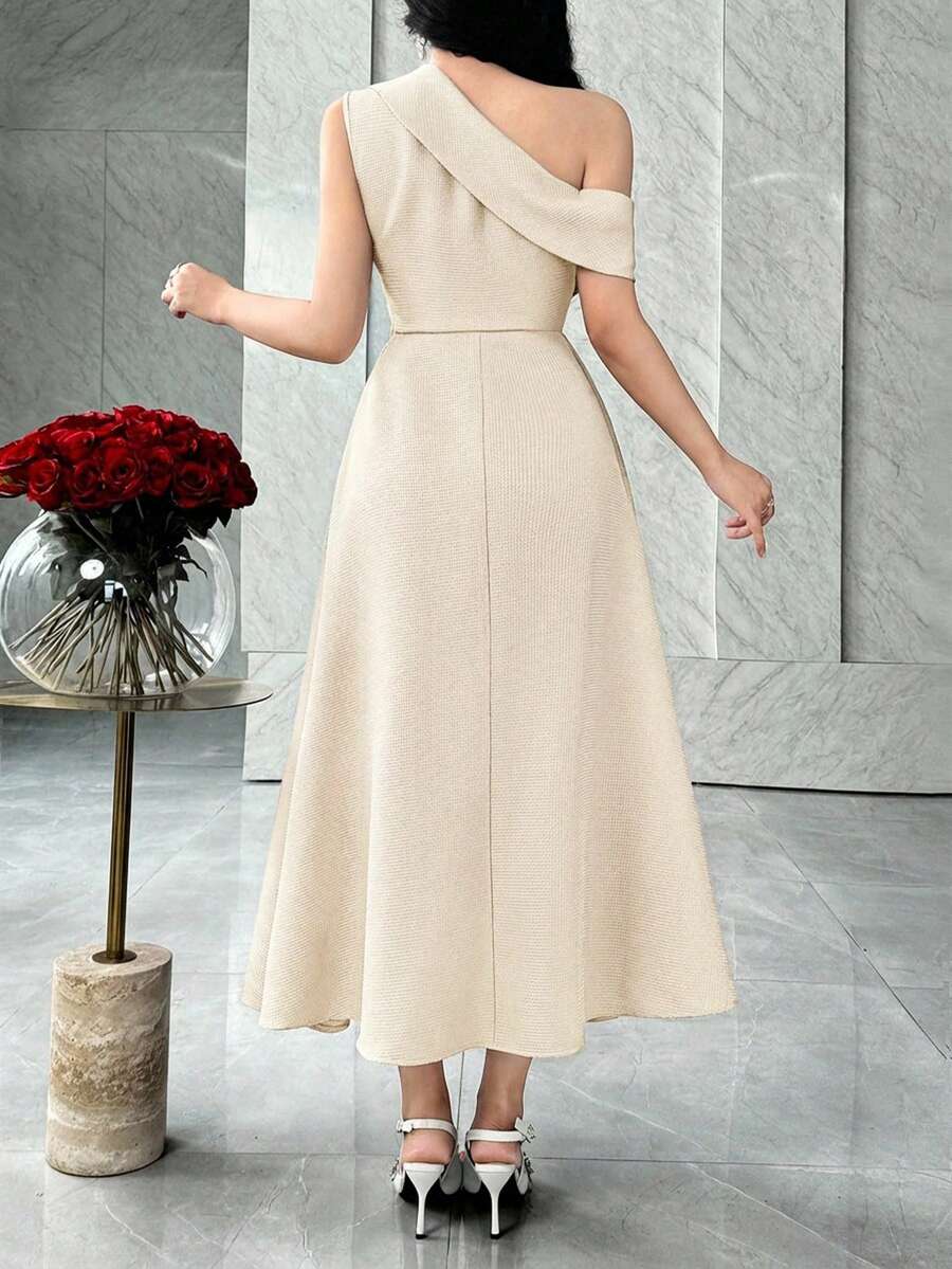 Back view of ivory asymmetric A-line midi dress with diagonal shoulder band in marble interior