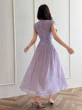 Back view of pale lilac A-line maxi dress with fitted high waist
