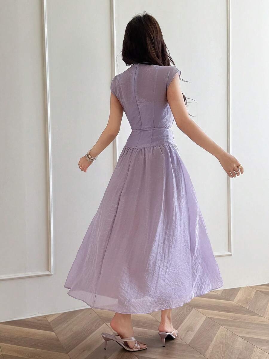 Back view of pale lilac A-line maxi dress with fitted high waist