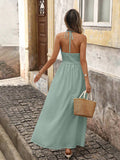 Back view of green boho halter maxi dress with open back and halter tie