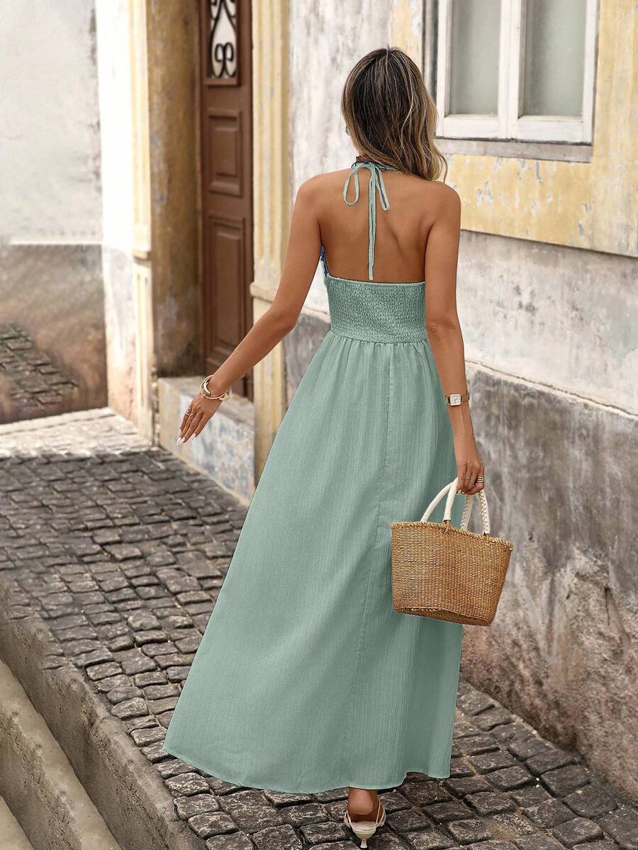 Back view of green boho halter maxi dress with open back and halter tie