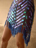 Close-up of purple sequin beach cover-up showing sheer mesh, hip detail, and pointed fringe