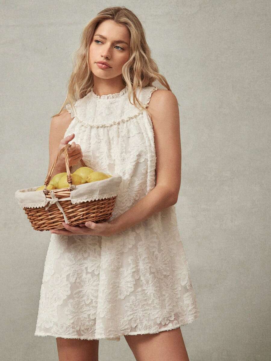 Step into a world of whimsical elegance with this chic ruffle neck floral applique babydoll mini dress, the ultimate sartorial choice for Summer 2026 festivals and tropical escapes. Defined by its voluminous babydoll silhouette and intricate 3D floral appliques, this dress offers a stunning tactile texture that radiates feminine charm. The delicate ruffle neckline adds a vintage-inspired touch, while the breezy, lightweight fabric ensures you remain cool and comfortable during sun-drenched beach vacations o