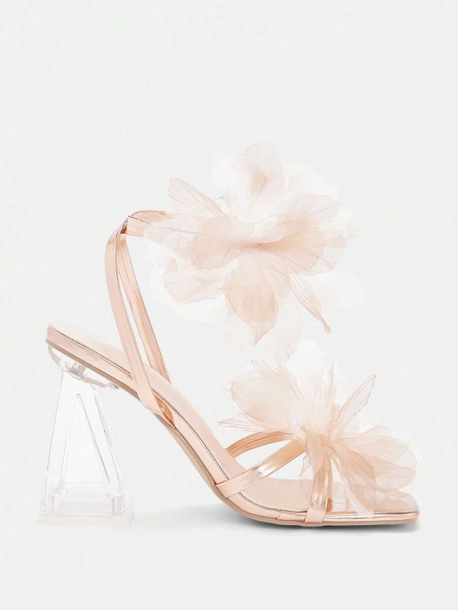 Studio side view of champagne floral high heel sandals with transparent heel