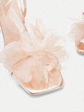 Top view of champagne metallic sandals with three-dimensional organza flower