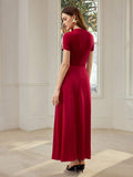Back view of ruby red ankle-length dress with high neckline, short sleeves, and concealed zipper