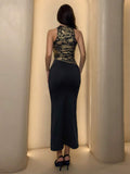 Back view of black and gold halter maxi dress with fitted silhouette