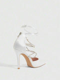 9 media show white black and pink satin pointed toe stiletto pumps with rhinestone crisscross instep cage straps, ankle wrap tie, side cutouts, tall back counter, back zipper. image 2