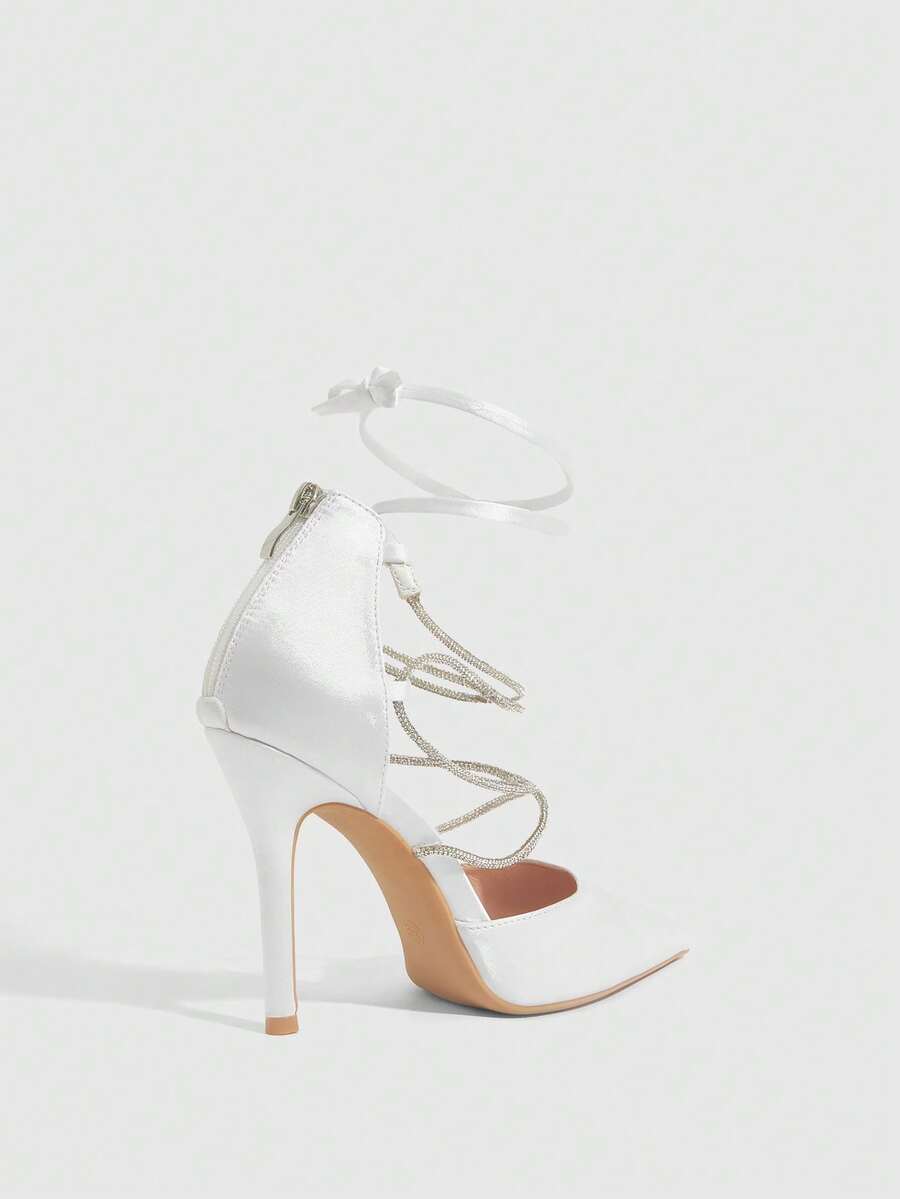 9 media show white black and pink satin pointed toe stiletto pumps with rhinestone crisscross instep cage straps, ankle wrap tie, side cutouts, tall back counter, back zipper. image 2