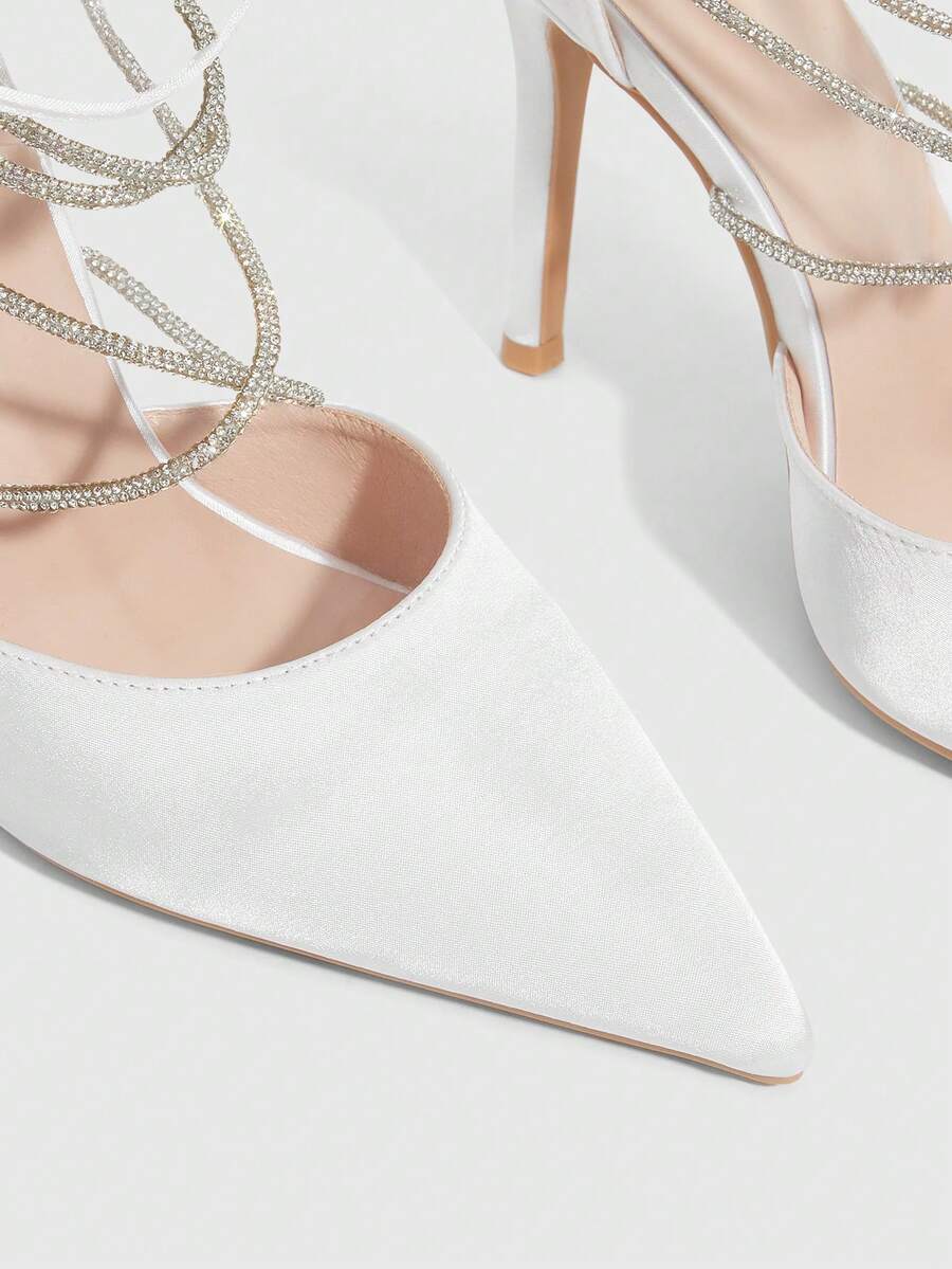 9 media show white black and pink satin pointed toe stiletto pumps with rhinestone crisscross instep cage straps, ankle wrap tie, side cutouts, tall back counter, back zipper. image 3
