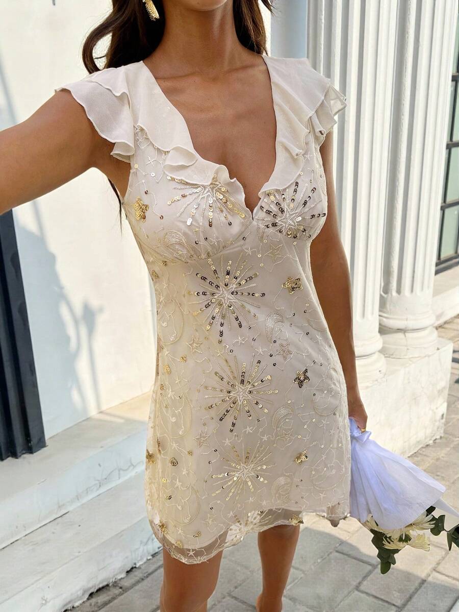 Close front view of champagne sequin party dress showing celestial embroidery and lined mesh