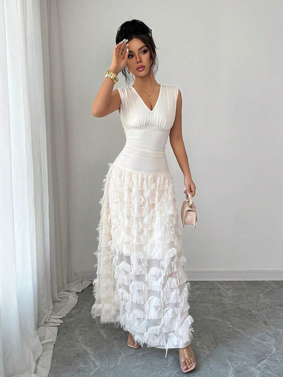 Elevate your summer wardrobe with this stunning chiffon tassel patchwork sleeveless dress. Designed for timeless elegance, this A-line silhouette features a flattering high waist, asymmetrical ruching, and a graceful flared hem. The V-neckline and plant-inspired pattern create a sophisticated look perfect for weddings and special occasions. Crafted from a premium blend of 90% polyester and 10% elastane with medium stretch, this knitted fabric offers comfort and durability. 