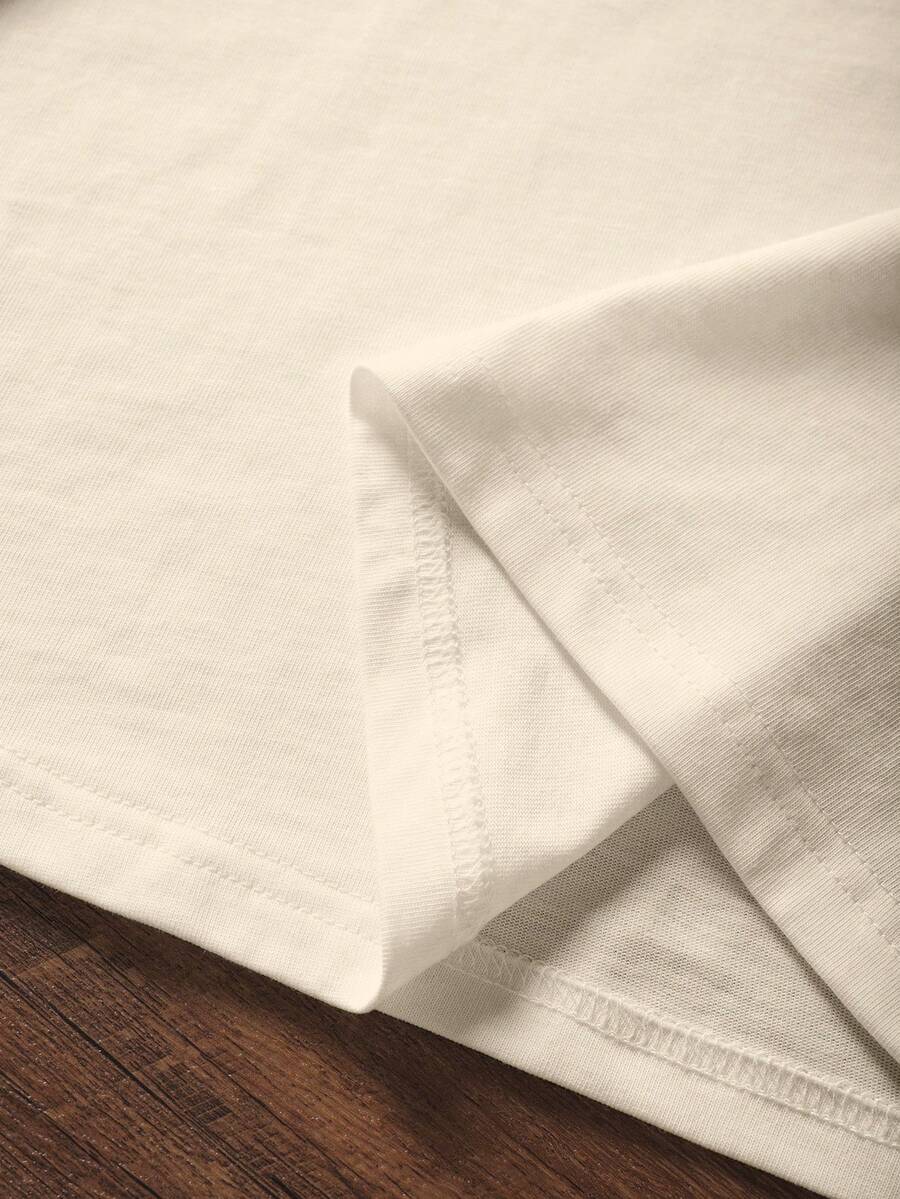 Close-up of apricot knitted T-shirt hem and overlocked inner seam construction