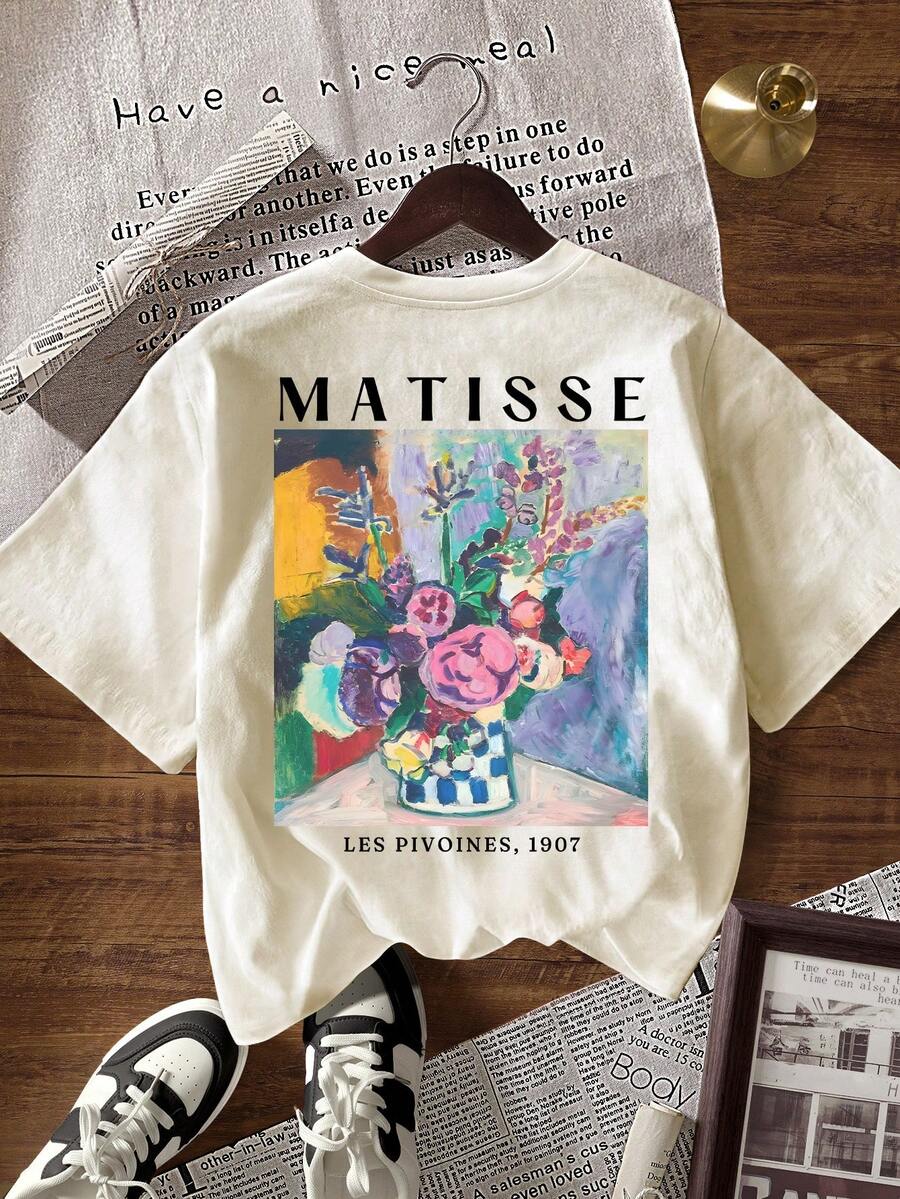 Flat lay of apricot short-sleeve T-shirt with large colorful Matisse floral print