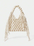 Ivory crochet hollow beach bag with round bead handle and side tassels