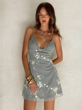 Detail view of pink floral embroidered spaghetti strap mini dress with applique detail