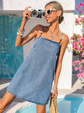 Front view of medium-light wash denim mini dress with beaded straps