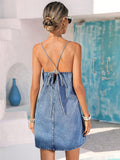 Back view of light denim cami dress with crossed bow tie closure
