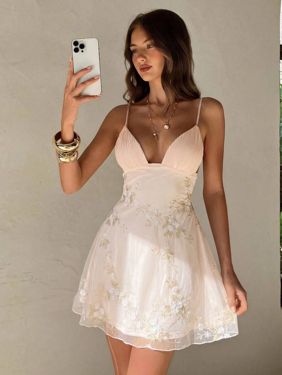 Back view of grey green floral embroidered spaghetti strap mini dress with low back