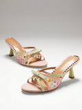 Pair of blush mint floral mesh mule heels with bow and flared heel