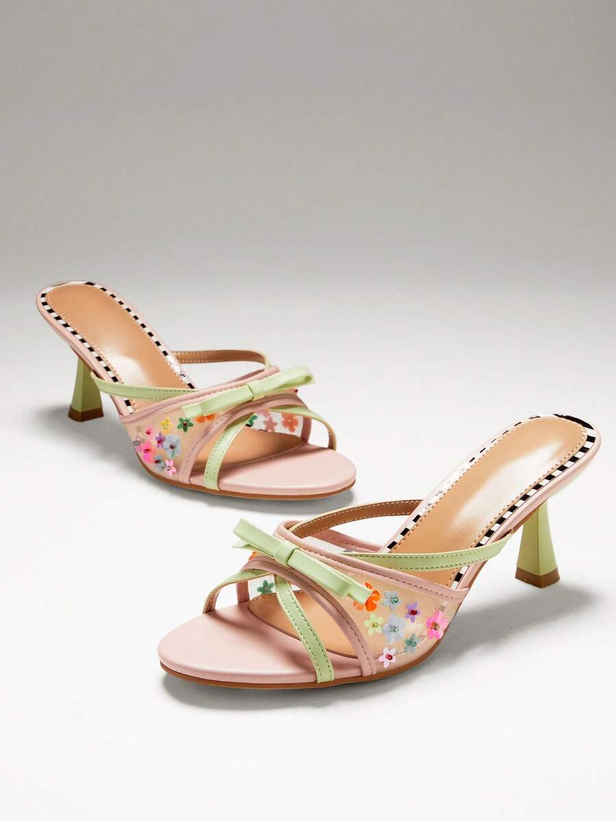 Pair of blush mint floral mesh mule heels with bow and flared heel