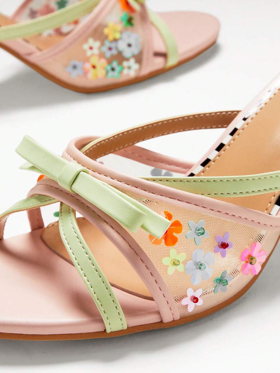 Close detail of blush mint floral applique mule heel with decorative bow