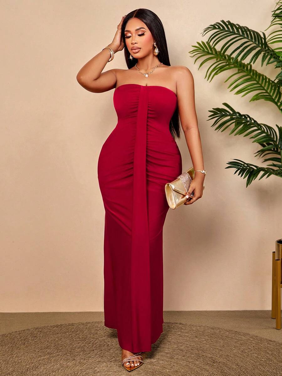 Make a statement in this stunning burgundy strapless bodycon maxi dress, designed for curves and confidence. The ruched mermaid silhouette hugs your figure beautifully while the flowing skirt creates an elegant, dramatic finish perfect for weddings, evening parties, and summer celebrations. Crafted for plus-size figures, this dress features a supportive strapless neckline and strategic ruching that flatters and defines. 