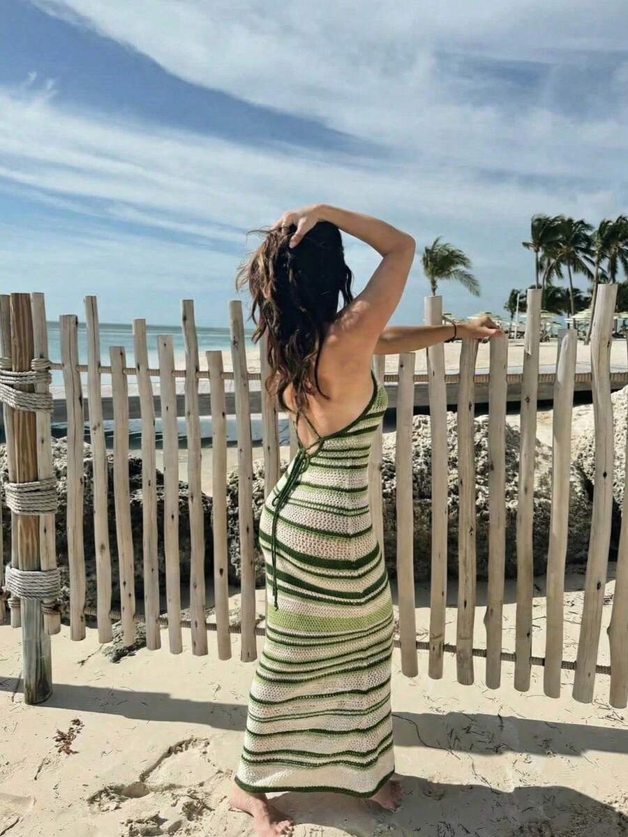 Elevate your warm-weather wardrobe with this striking sleeveless knit dress featuring a halter neckline and eye-catching striped pattern. The backless design and hollow-out details create an effortlessly chic silhouette, while the slim fit and semi-sheer knitwear offer comfort and style. Perfect for beach days, vacations, and festive celebrations, this versatile piece transitions seamlessly from day to night. Crafted from 100% polyester with slight stretch for ease of movement, it's an ideal choice for spri