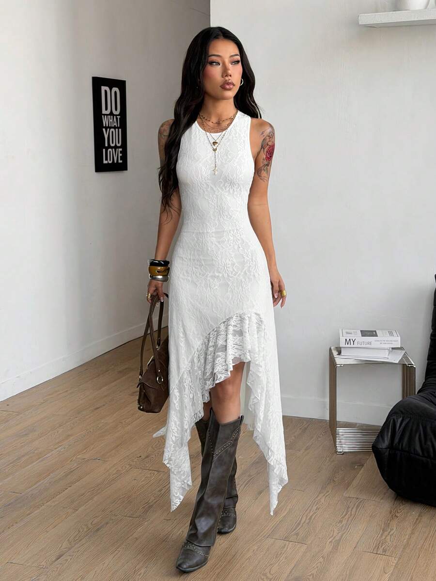 Front view of white sleeveless lace dress with fitted shape and long asymmetric skirt panels