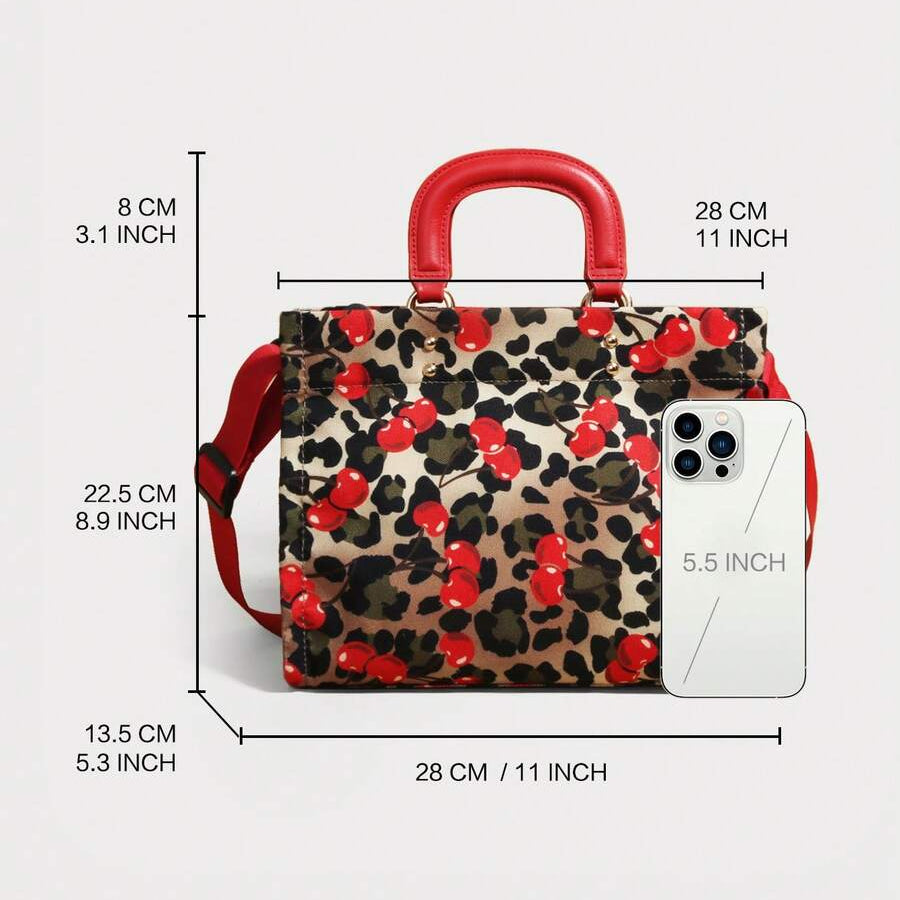 Size diagram of cherry and leopard-print handbag with red handles and phone for scale