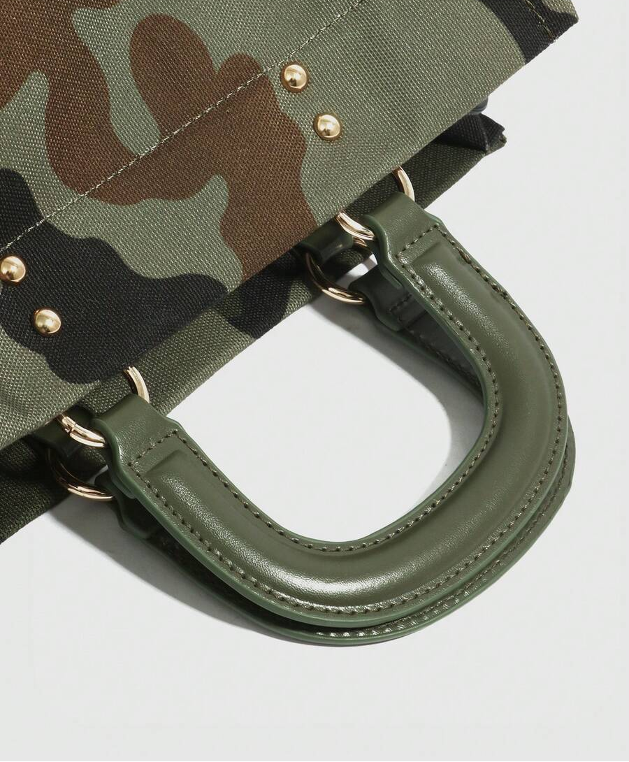 Close-up of olive handbag handle stitching, gold-tone rings and rivets on green camouflage fabric