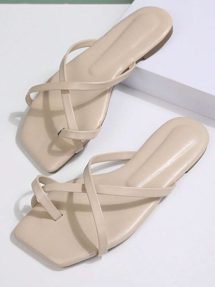 Apricot beige cross-strap flat sandals in a paired product view