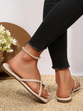 Rear side view of white cross-strap sandals showing open heels and flat soles