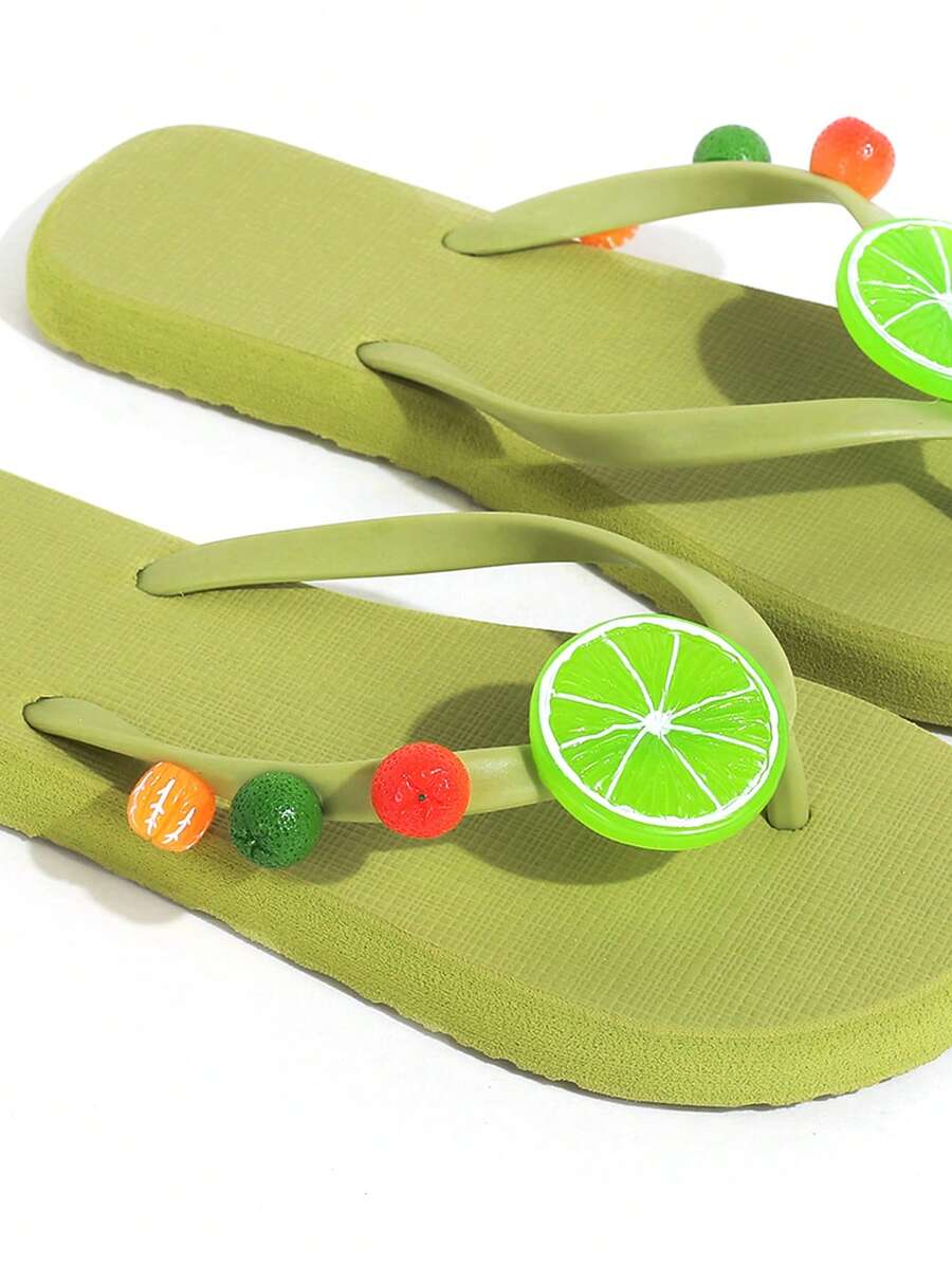 Product-only close view of green flip-flops with colorful citrus charms