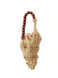 Natural straw woven shell handbag with amber gem studs and tan lining