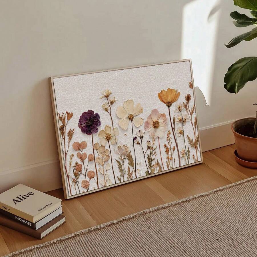 Floor-leaning farmhouse botanical canvas print beside books and a potted plant