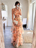Back view of salmon floral halter top and high-waist tiered skirt