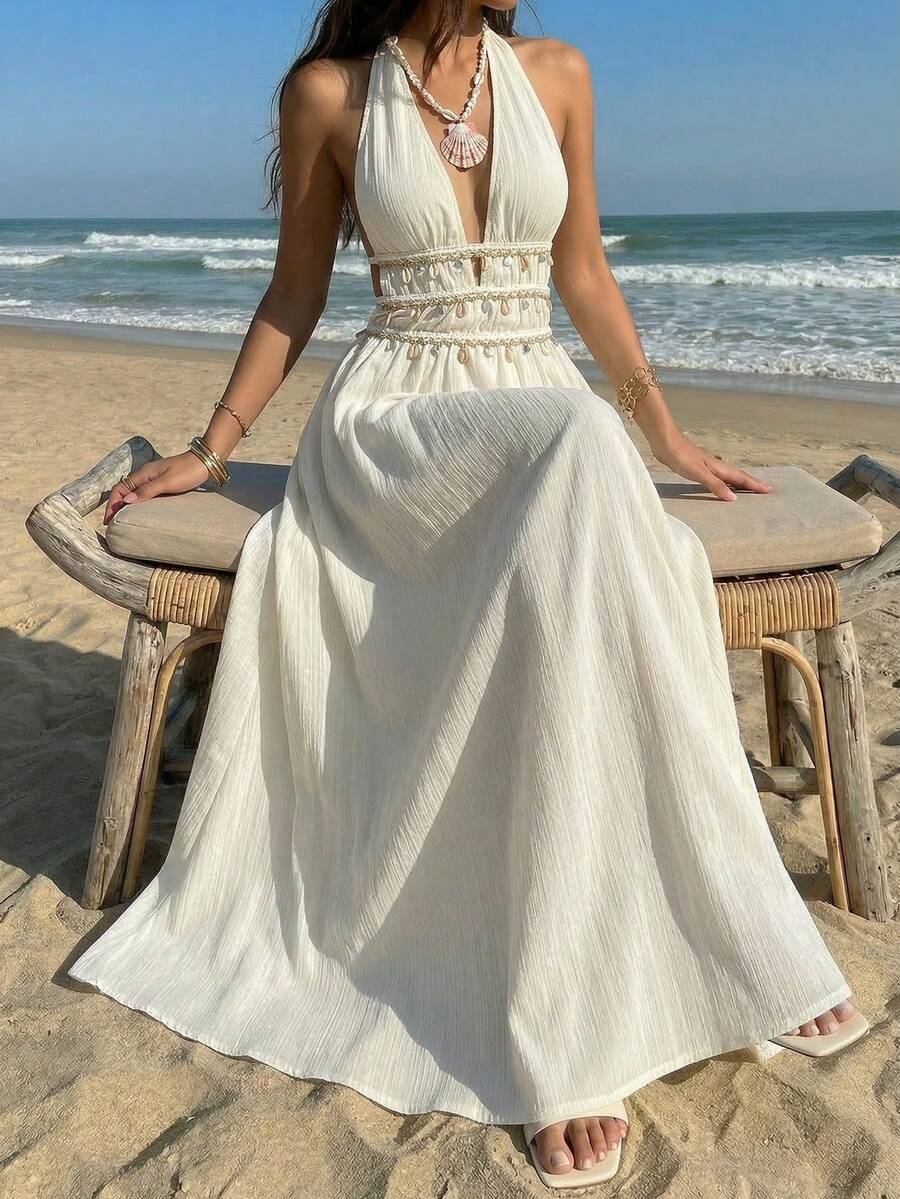White halter maxi dress with shell trim styled at the beach