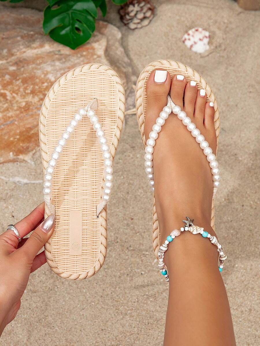 Overhead cream woven-look flip-flops with white pearl straps at a beach set