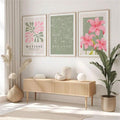 Three abstract Matisse-inspired botanical, Picasso-style line art and pink lily framed prints above a wood console