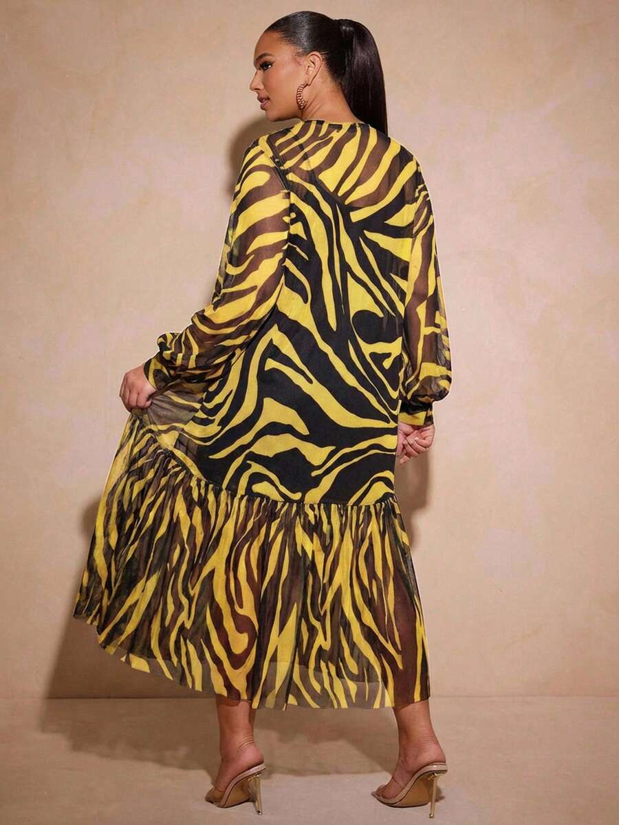Rear view of yellow zebra print long dress with sheer sleeves and flowing lower tier
