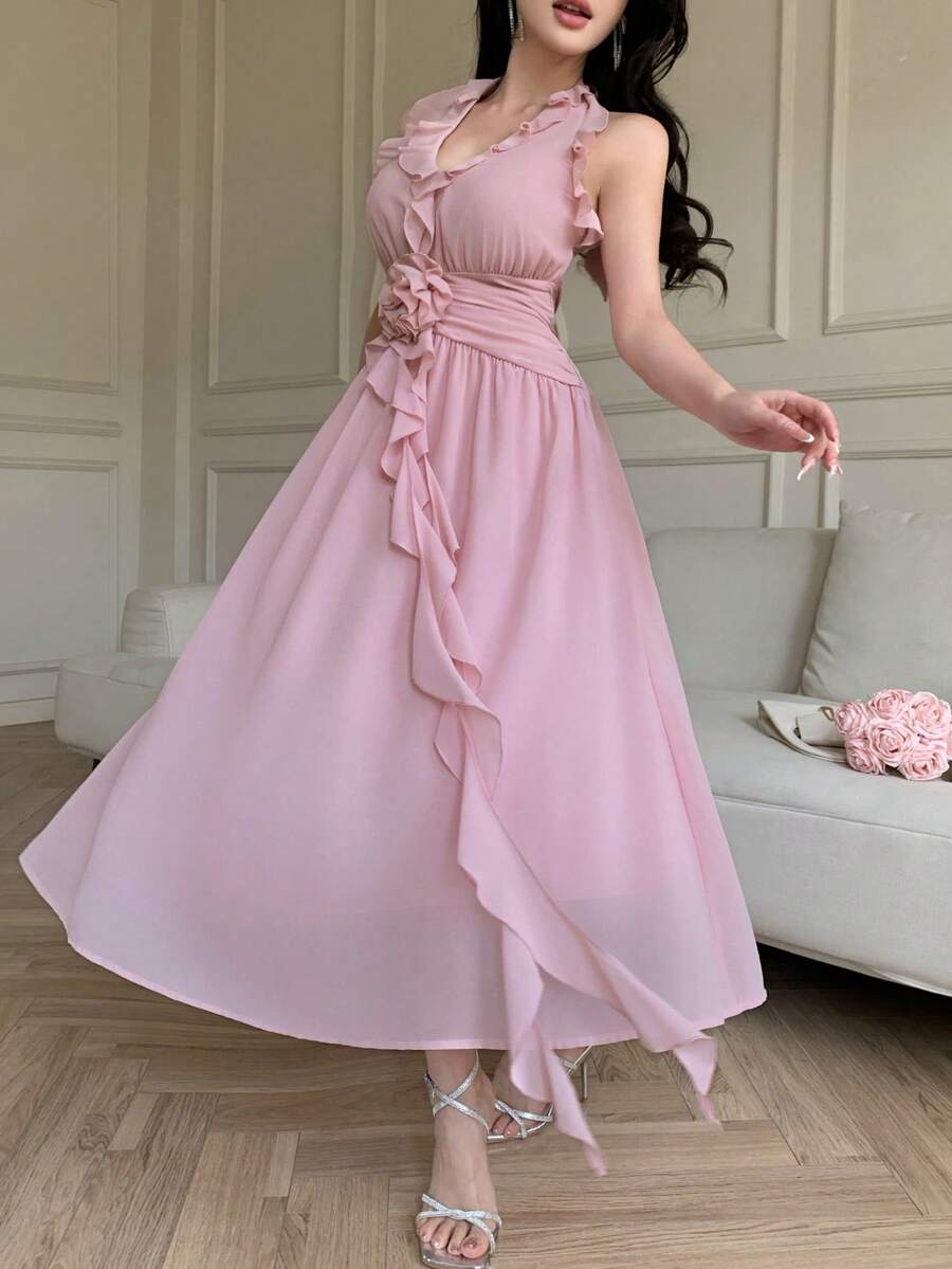 Pale pink sleeveless halter dress with waist rose and flowing skirt