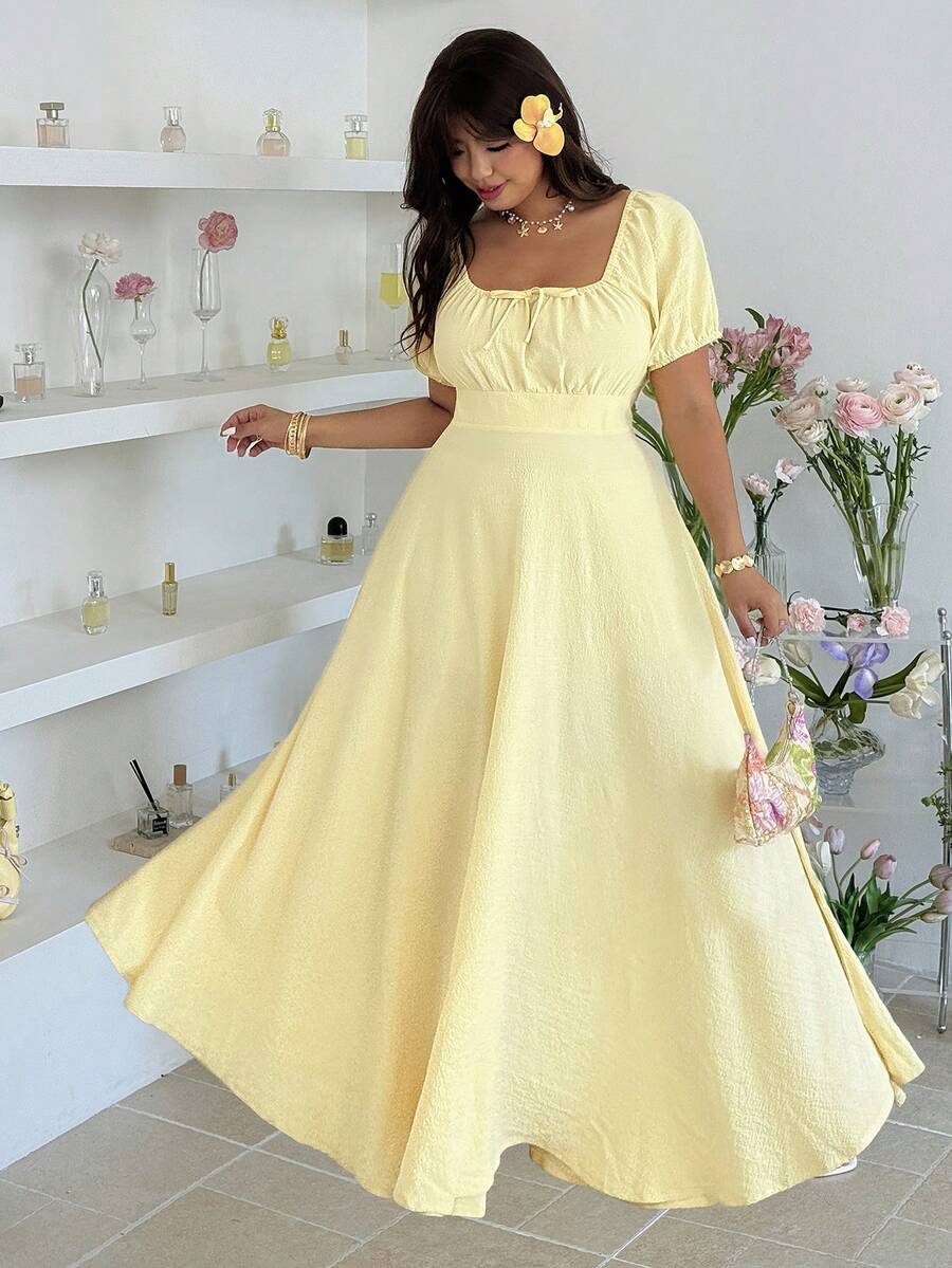 Elevate your wardrobe with this versatile plus-size dress designed for effortless elegance. The twist detail at the bodice and ruched waist create a flattering silhouette that defines and slims while maintaining all-day comfort. Crafted in a timeless solid color, this piece transitions seamlessly from casual outings to special occasions.