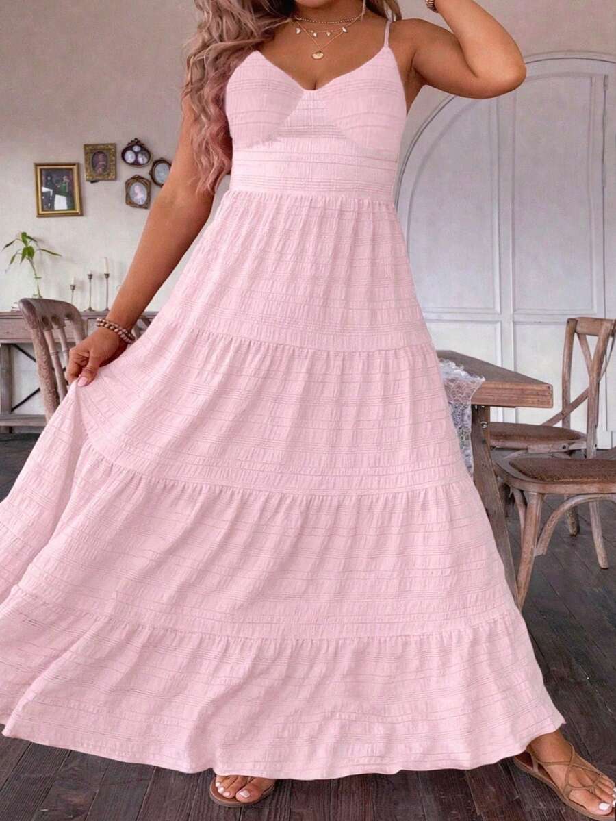  Elevate your summer wardrobe with this sophisticated plus-size maxi cami dress. Crafted for confident style, the relaxed cami neckline and flowing silhouette create an effortlessly chic look that celebrates your shape. The signature ruffled hem adds movement and dimension, perfect for everything from beach days to evening strolls.