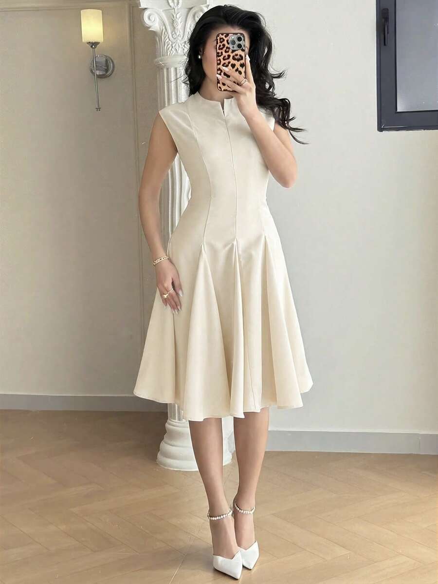 Cream sleeveless fit-and-flare midi dress with notch collar and pleated skirt, front view on model