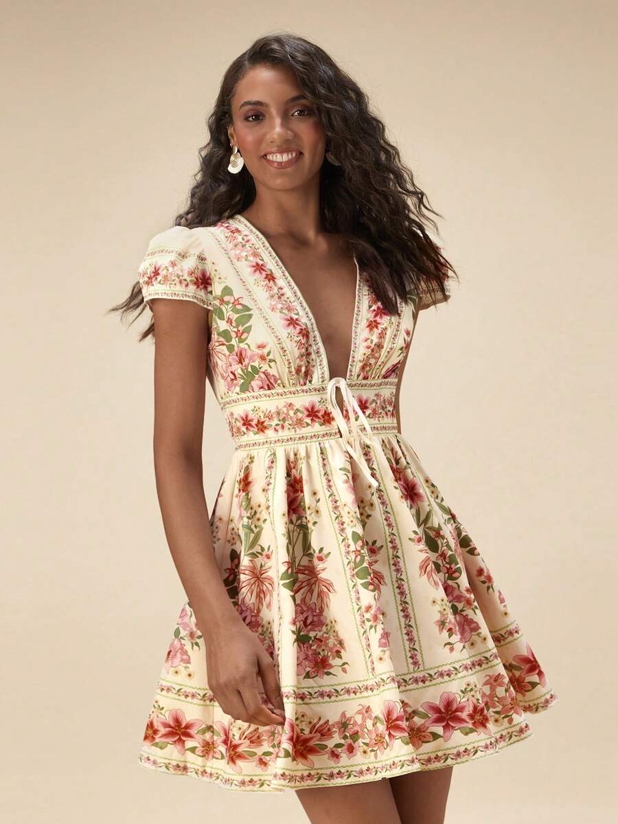 Embrace effortless elegance with this chic retro printed dress, perfect for your next getaway. Featuring a flattering deep V-neckline, delicate ruffled puff sleeves, and a cinched high waist that defines your silhouette, this piece combines vintage charm with modern comfort. The A-line, fit-and-flare cut with a flared hem creates beautiful movement, while the botanical print in multicolor adds a playful boho touch. Crafted from a breathable woven fabric blend of 95% polyester and 5% elastane.